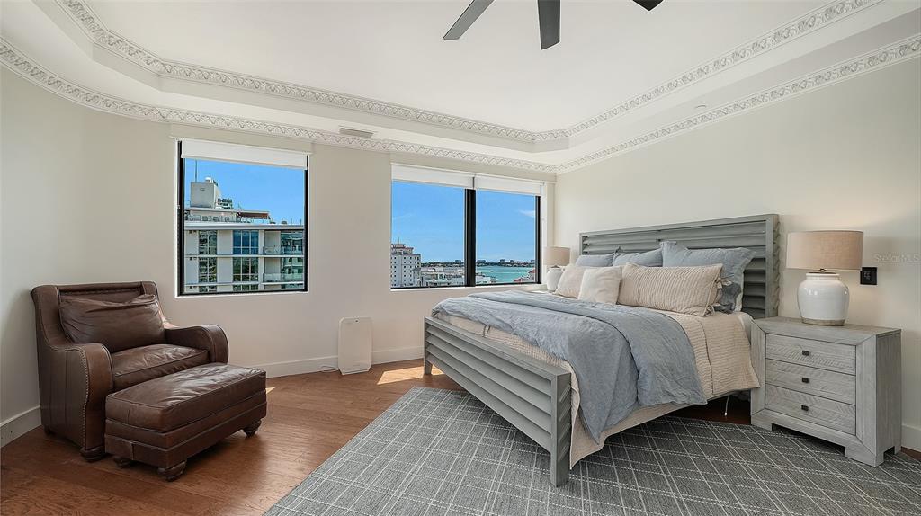128 Golden Gate Point, Unit 901/1001 Sarasota, FL 34236 - Photo 20 of 55 a bedroom with a bed and a couch