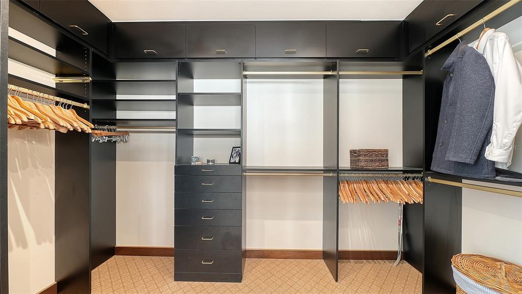 128 Golden Gate Point, Unit 901/1001 Sarasota, FL 34236 - Photo 21 of 55 a view of walk in closet with clothes and shoes