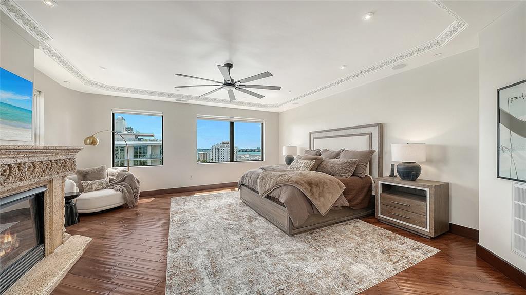 128 Golden Gate Point, Unit 901/1001 Sarasota, FL 34236 - Photo 30 of 55 a spacious bedroom with a bed and a couch