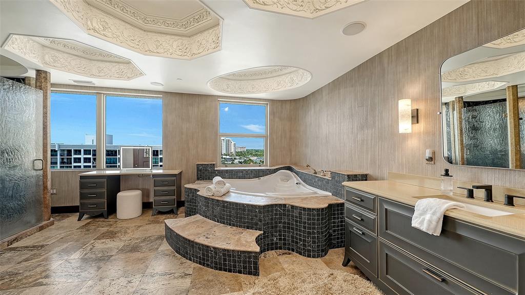 128 Golden Gate Point, Unit 901/1001 Sarasota, FL 34236 - Photo 32 of 55 a spacious bathroom with a granite countertop tub and a sink
