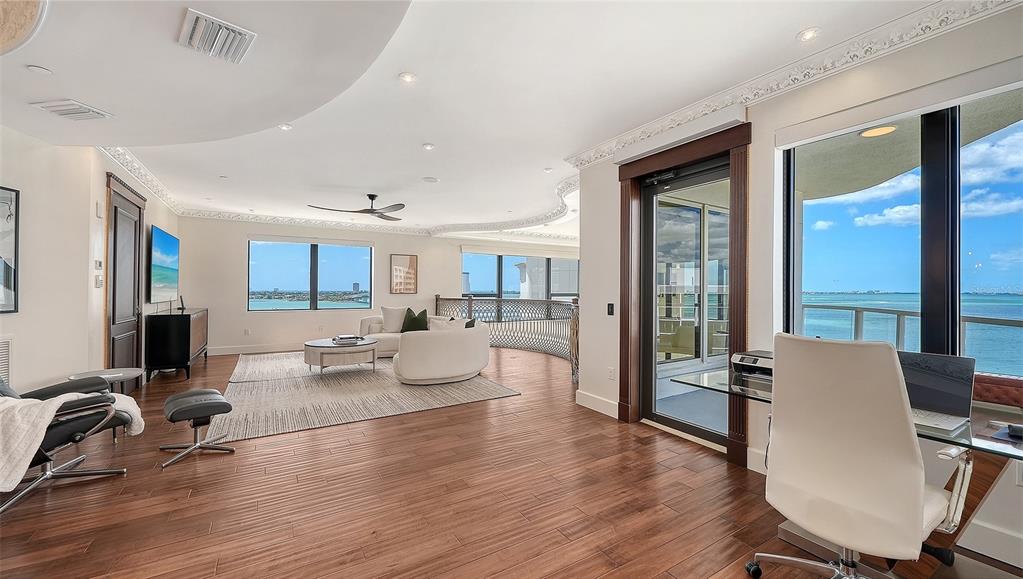 128 Golden Gate Point, Unit 901/1001 Sarasota, FL 34236 - Photo 36 of 55 a living room with furniture or wooden floor and a large window