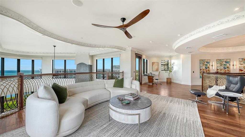 128 Golden Gate Point, Unit 901/1001 Sarasota, FL 34236 - Photo 37 of 55 a living room with furniture and a wooden floor
