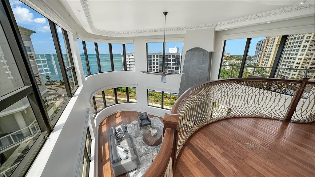 128 Golden Gate Point, Unit 901/1001 Sarasota, FL 34236 - Photo 38 of 55 a view of a balcony with furniture and wooden floor