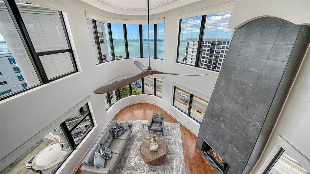 128 Golden Gate Point, Unit 901/1001 Sarasota, FL 34236 - Photo 39 of 55 a view of livingroom with furniture staircase and a kitchen view