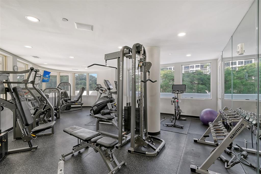 128 Golden Gate Point, Unit 901/1001 Sarasota, FL 34236 - Photo 49 of 55 a view of a room with gym equipment