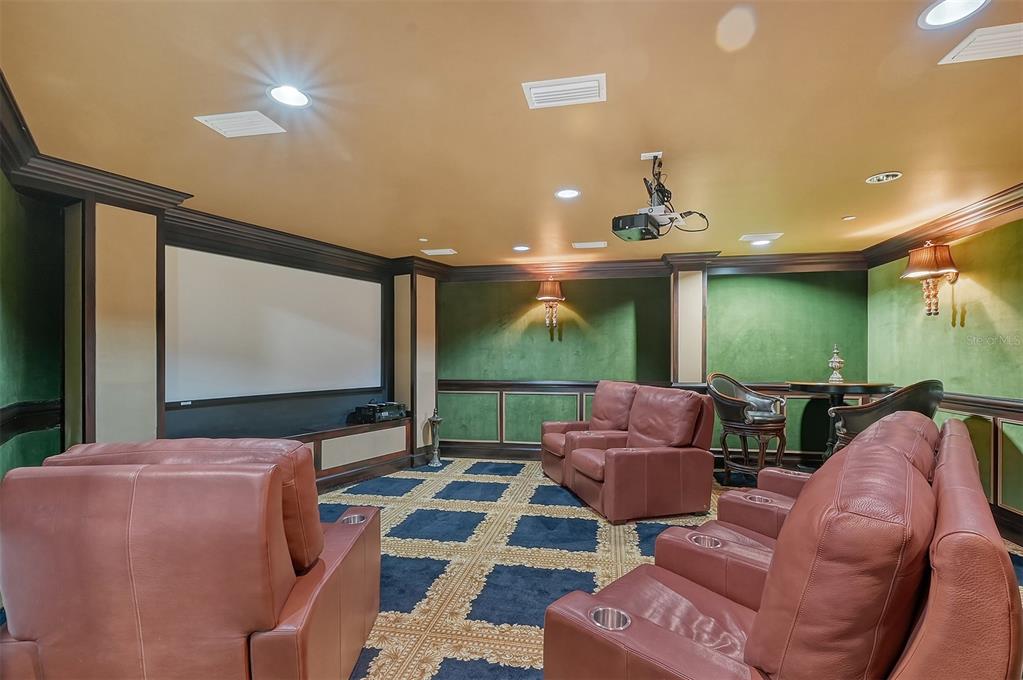 128 Golden Gate Point, Unit 901/1001 Sarasota, FL 34236 - Photo 50 of 55 a living room with furniture and a flat screen tv