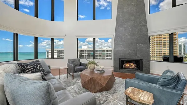a view of a patio with a table chairs and a floor to ceiling window