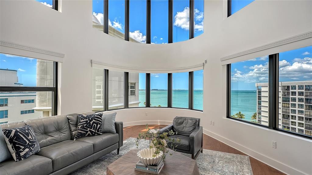 128 Golden Gate Point, Unit 901/1001 Sarasota, FL 34236 - Photo 9 of 55 a living room with furniture and a large window