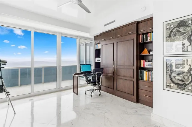 a bedroom with a large bed and a large window