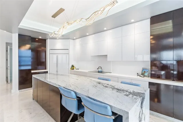 a kitchen with a sink a refrigerator and cabinets