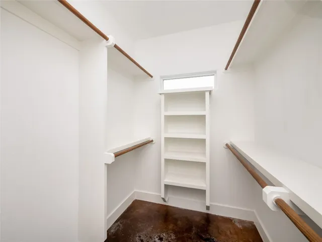 a bedroom with a large bed and a potted plant