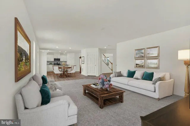 a living room with furniture fireplace and rug
