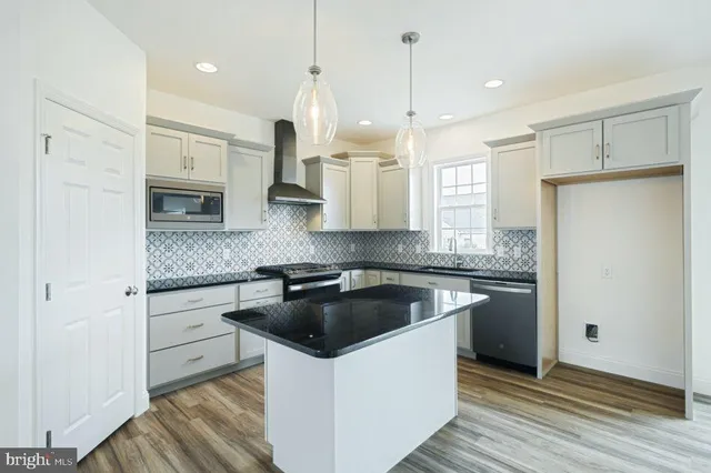 a kitchen with a refrigerator sink and stove