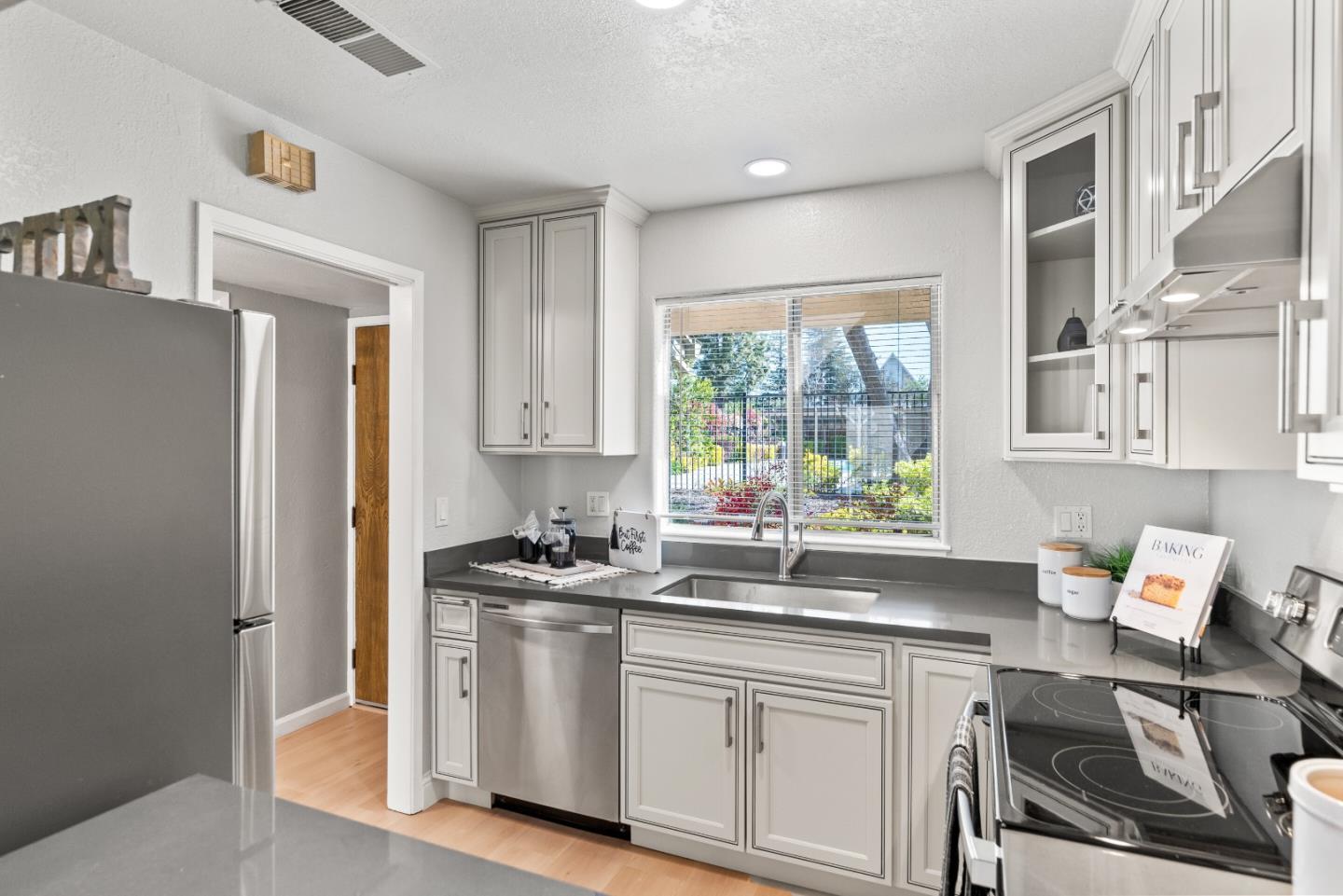 1264 Riesling Terrace Sunnyvale, CA 94087 - Photo 14 of 30 a kitchen with stainless steel appliances white cabinets a sink and a stove