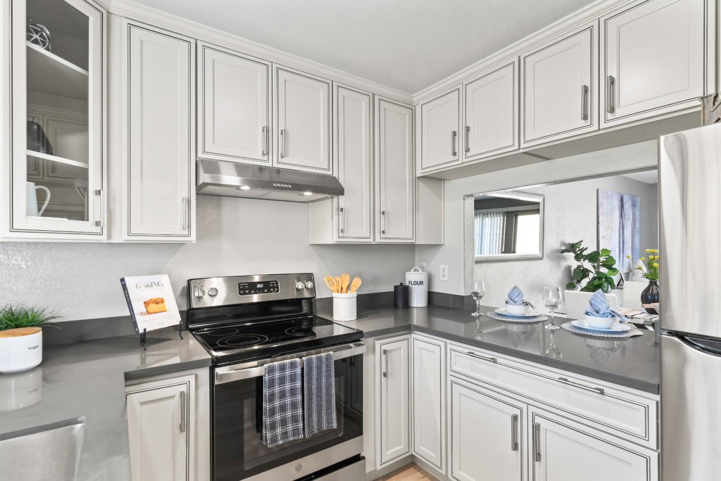 1264 Riesling Terrace Sunnyvale, CA 94087 - Photo 15 of 30 a kitchen with stainless steel appliances granite countertop a stove a sink and white cabinets