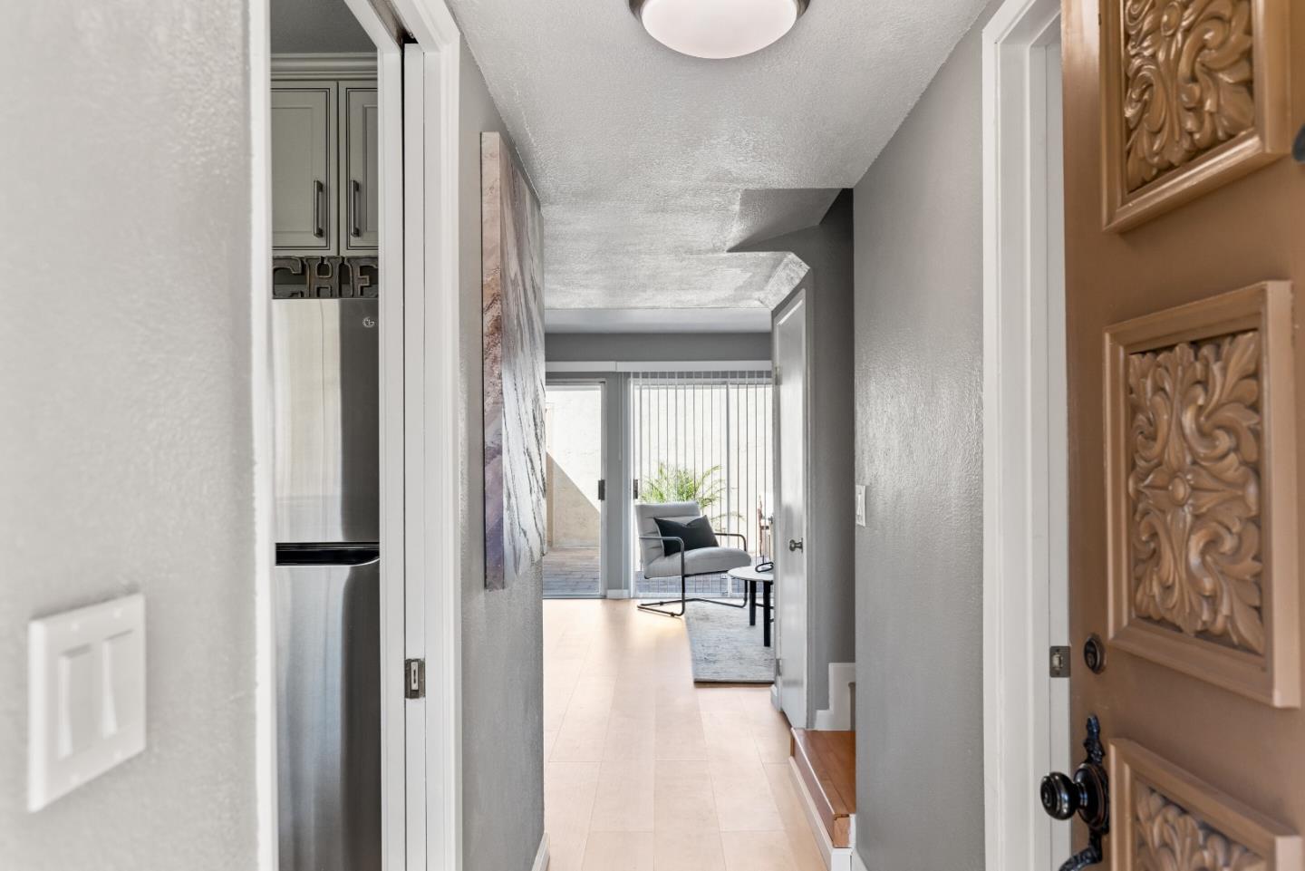 1264 Riesling Terrace Sunnyvale, CA 94087 - Photo 4 of 30 a view of a hallway with wooden floor windows and a livingroom with furniture