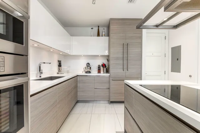 a kitchen with a sink cabinets and window