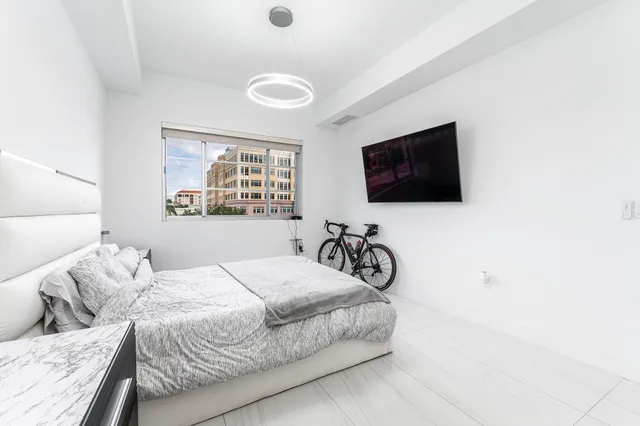 a bedroom with a bed and a flat screen tv