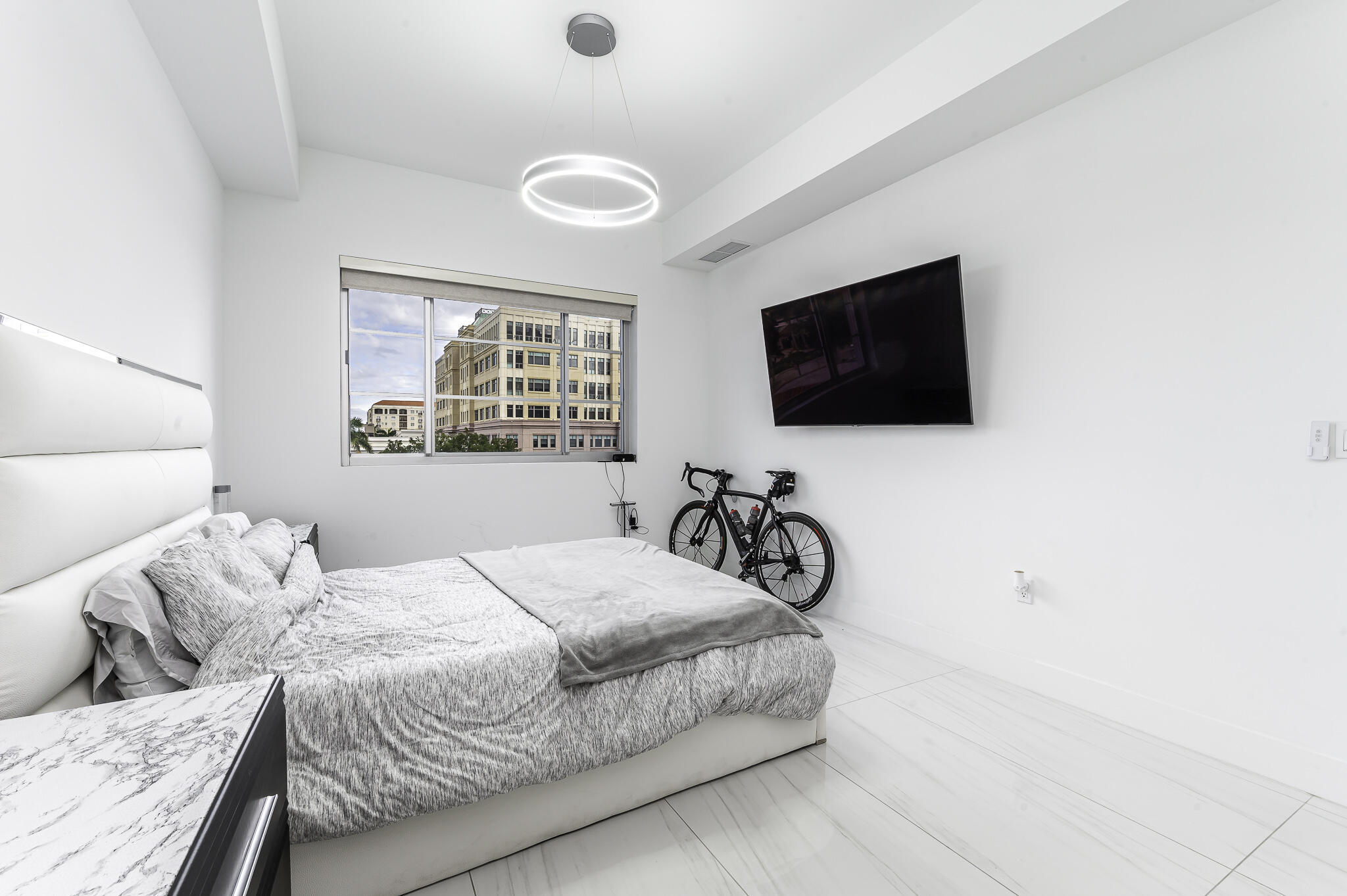 155 East Boca Raton Road, Unit 415 Boca Raton, FL 33432 - Photo 12 of 41 a bedroom with a bed and a flat screen tv