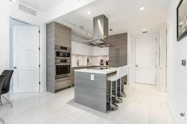 a kitchen with a refrigerator and countertop sink