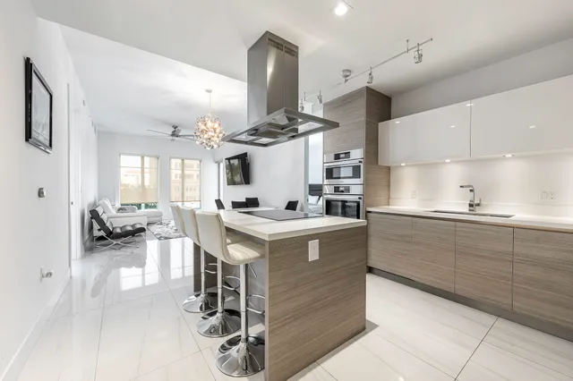 a kitchen with a stove cabinets and chairs