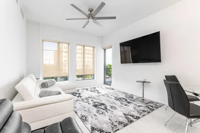 a spacious bedroom with a bed and a flat screen tv