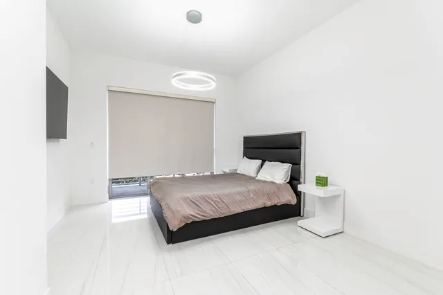 a bedroom with a bed and a mirror