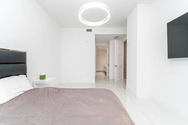 a bedroom with a bed and a mirror