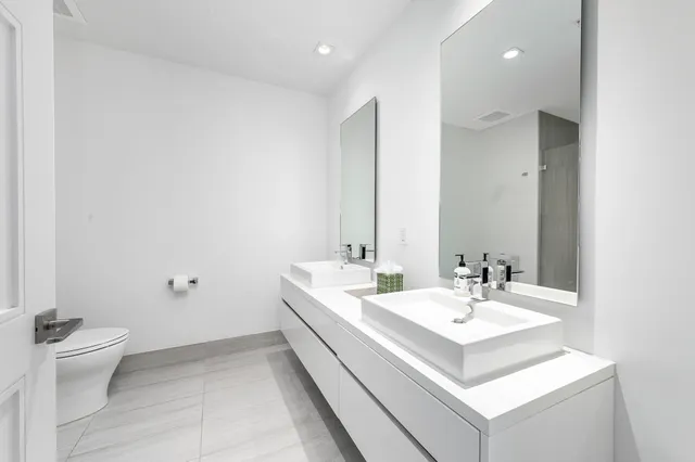 a bathroom with a sink toilet and a mirror