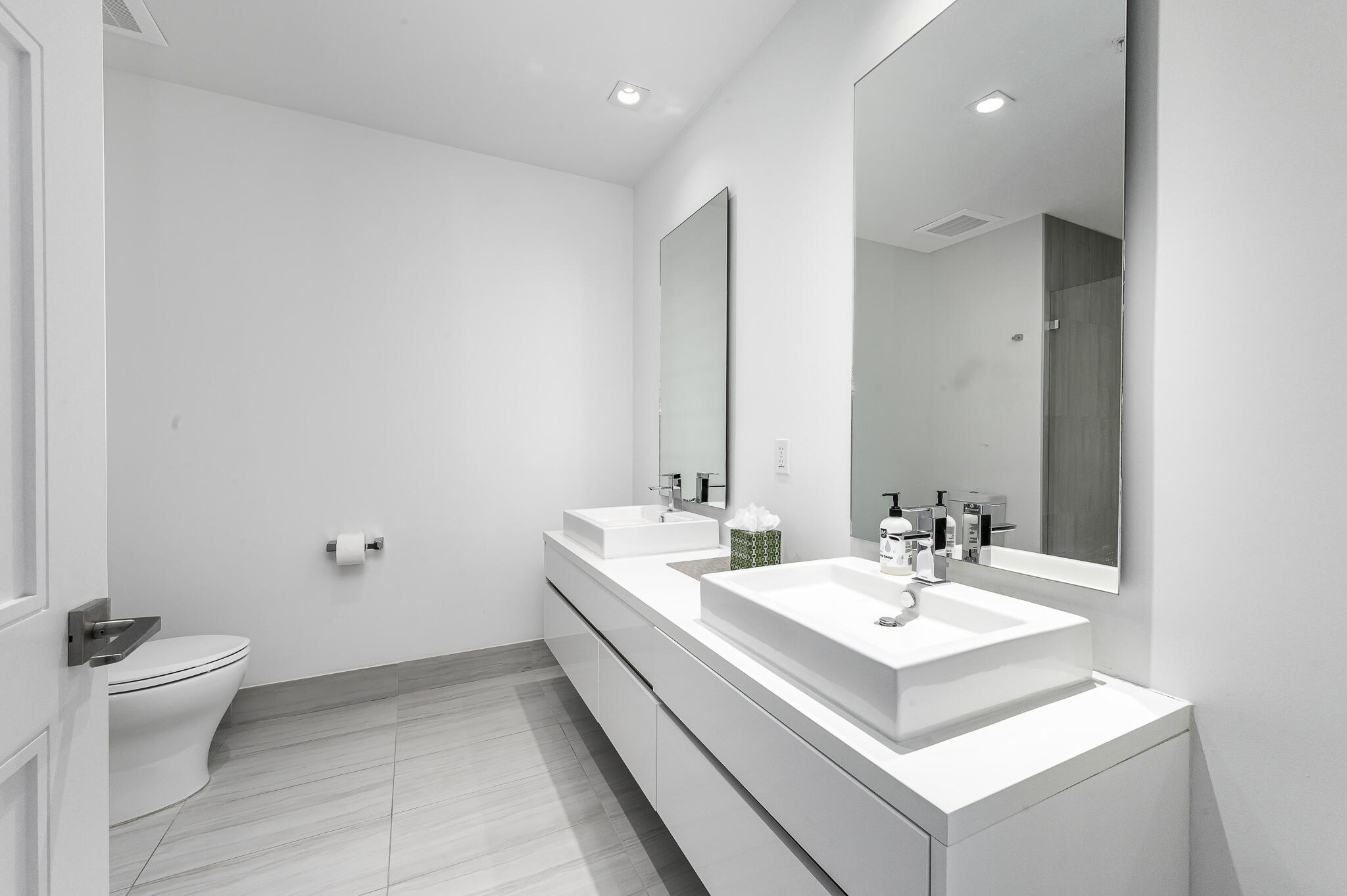 155 East Boca Raton Road, Unit 415 Boca Raton, FL 33432 - Photo 9 of 41 a bathroom with a sink toilet and a mirror