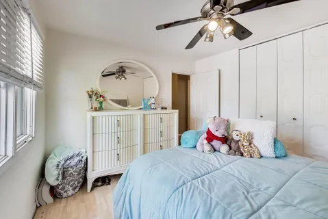 a bedroom with a bed and a chandelier