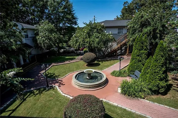 a backyard of a house with fire pit and outdoor seating