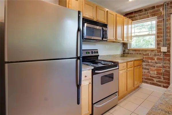 a kitchen with stainless steel appliances white cabinets and a stove top oven