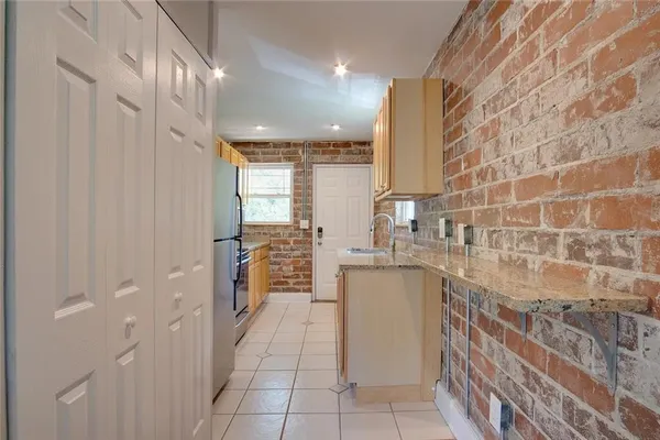a kitchen with stainless steel appliances granite countertop a sink and cabinets