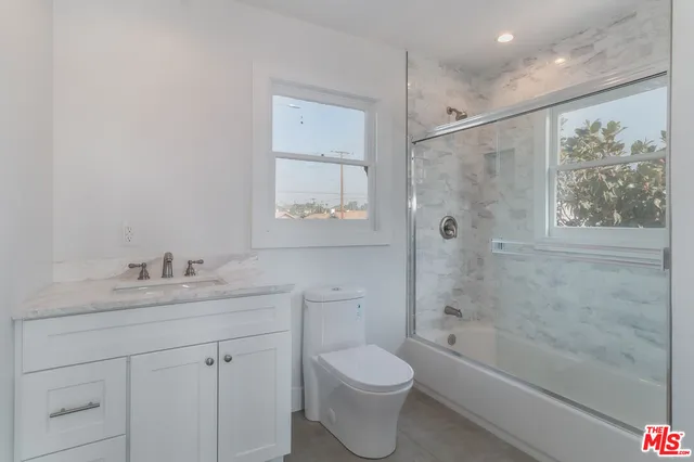 a bathroom with a glass shower door