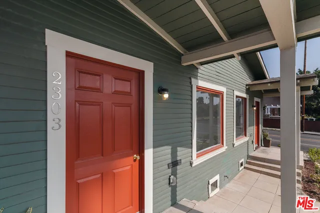a kitchen with a refrigerator and white cabinets