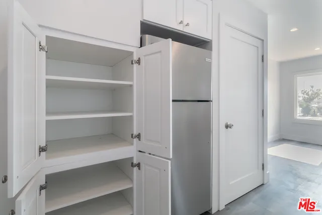 a bathroom with a shower sink vanity and mirror