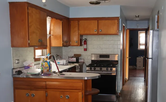 a kitchen with a stove a sink and cabinets