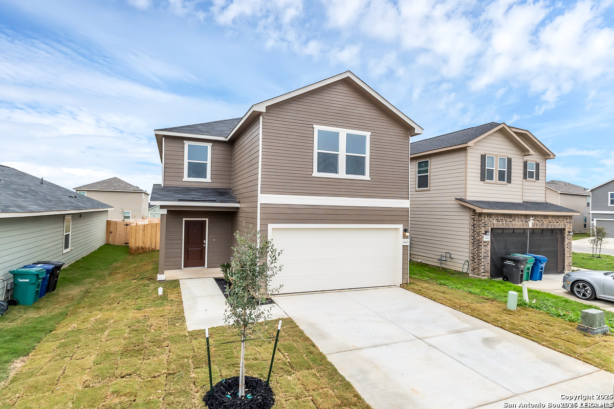 14458 Ribbon Tail Elmendorf, TX 78112 - Photo 2 of 22 a front view of house with yard outdoor seating and barbeque oven