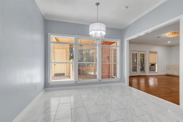 a spacious bedroom with a large bed and a flat screen tv