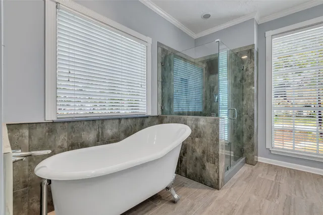 a bathroom with a granite countertop sink a mirror and a shower