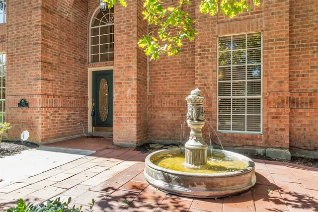 a front view of a house with a garden and plants