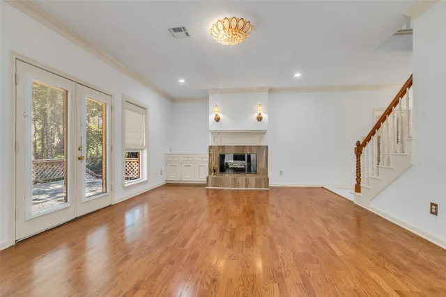 a view of an empty room with a fireplace and a window