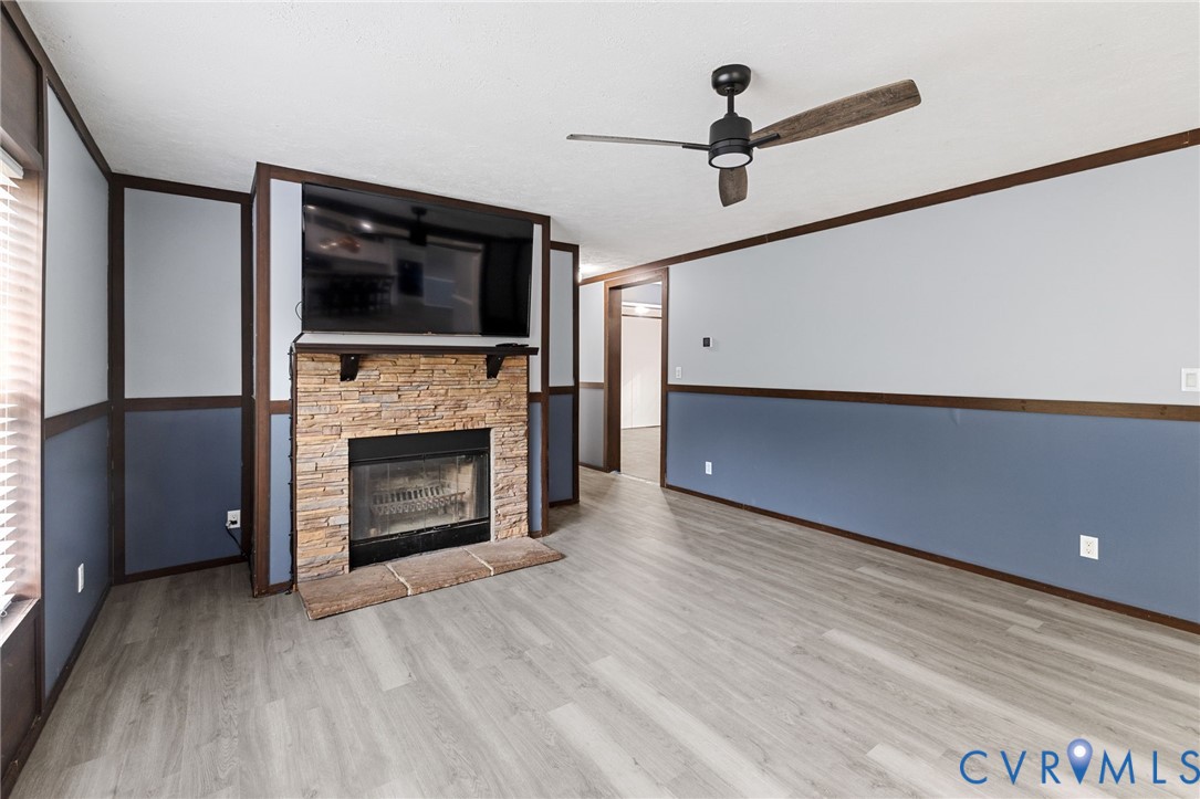 11391 Watkins Road Rockville, VA 23146 - Photo 13 of 28 a living room with a fireplace and a flat screen tv