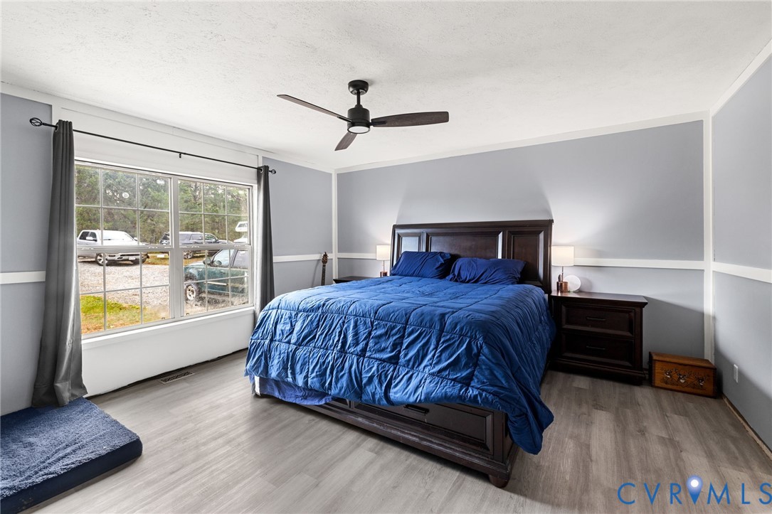 11391 Watkins Road Rockville, VA 23146 - Photo 20 of 28 a bedroom with a large bed and a window