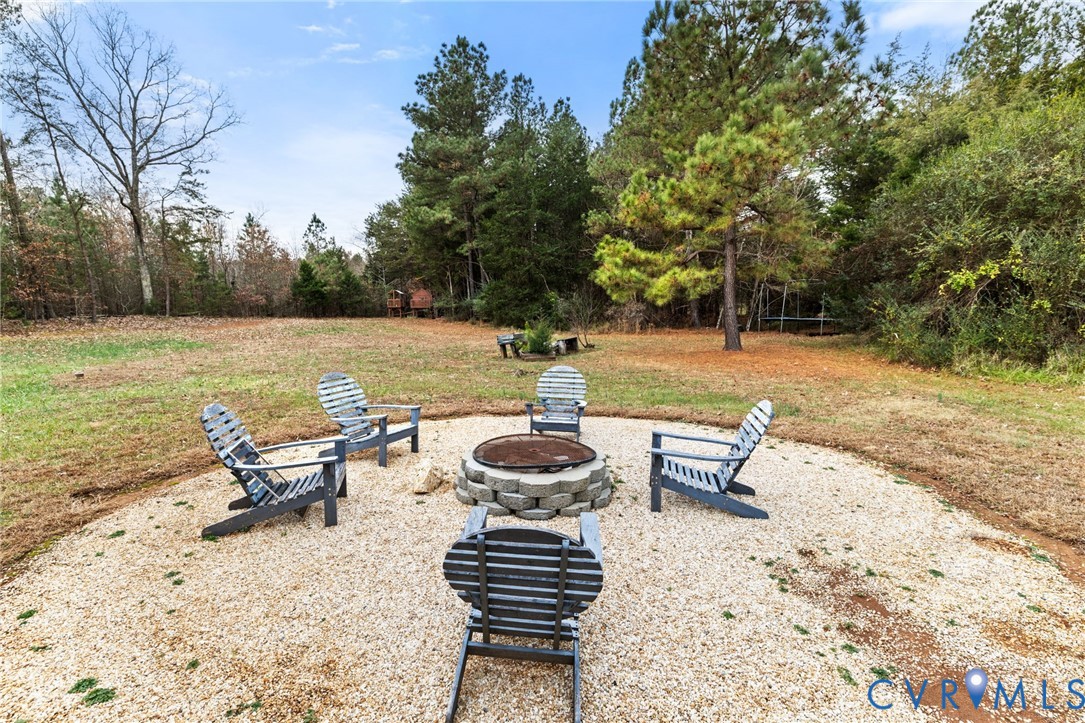 11391 Watkins Road Rockville, VA 23146 - Photo 26 of 28 a view of a lake with a lounge chair