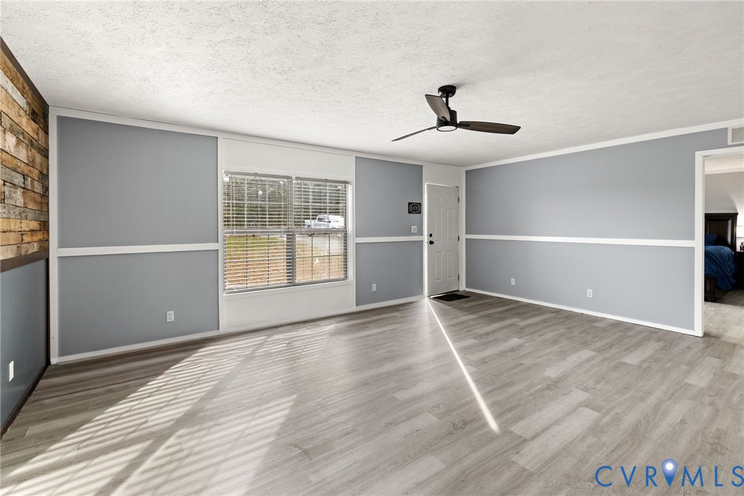 11391 Watkins Road Rockville, VA 23146 - Photo 3 of 28 a view of an empty room with wooden floor and a window