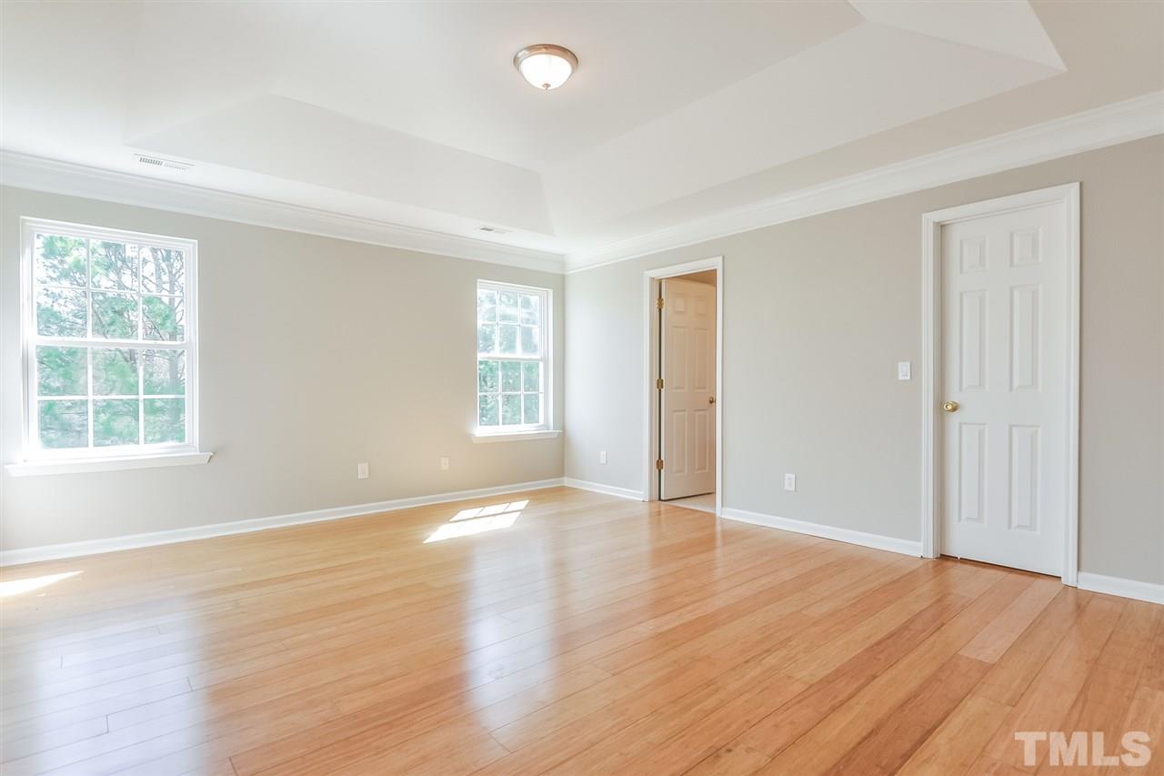 5100 Marathon Lane Raleigh, NC 27616 - Photo 13 of 24 an empty room with wooden floor and windows