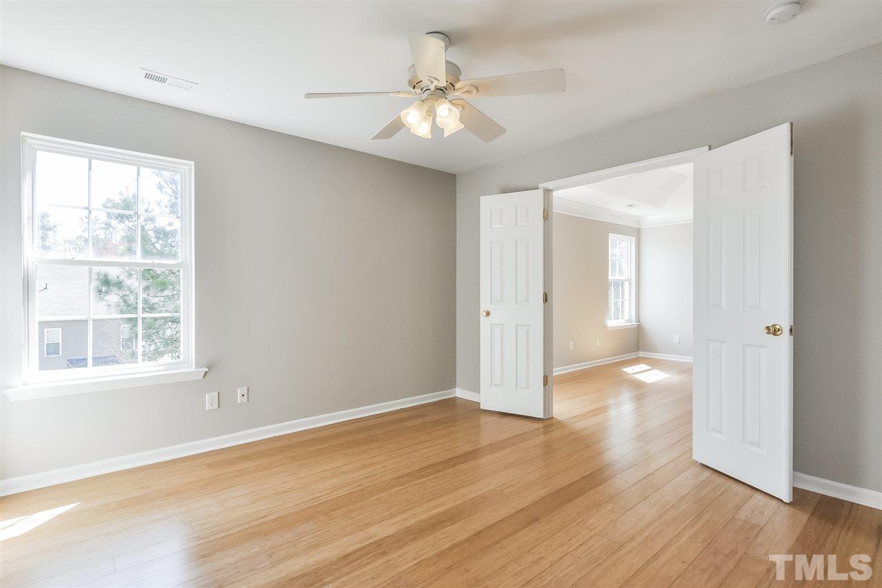 5100 Marathon Lane Raleigh, NC 27616 - Photo 17 of 24 a view of an empty room with wooden floor and a window