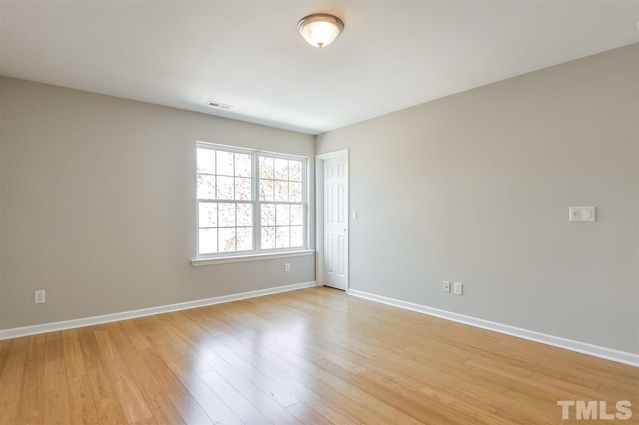 5100 Marathon Lane Raleigh, NC 27616 - Photo 18 of 24 an empty room with wooden floor and windows